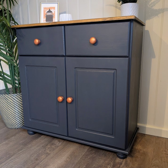 blue cupboard with copper handles