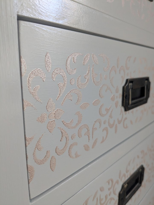 light grey chest of drawers with stencil detail