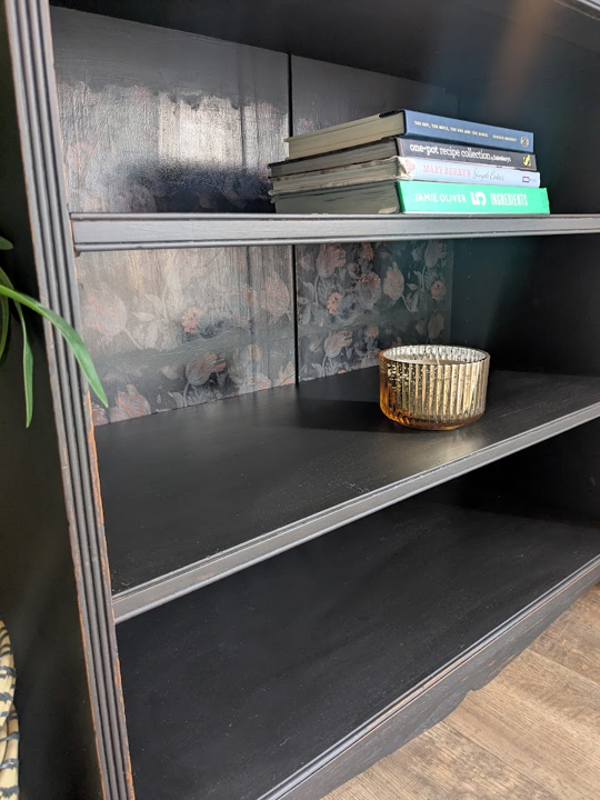 black bookcase with floral detail