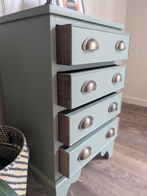 bedside cabinet in green drawers open from side