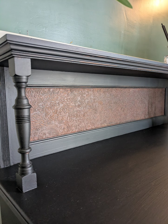 ornate bookcase with leather detail