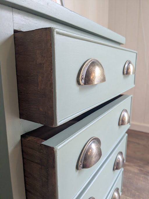 bedside table in green drawers open