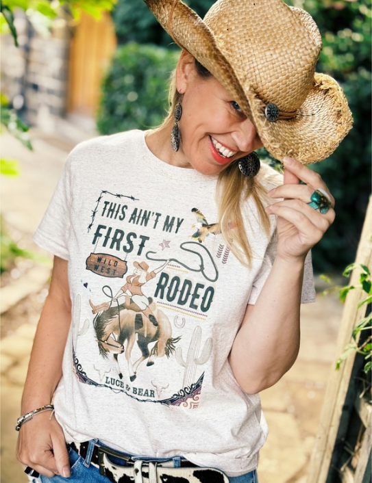Woman wearing This Ain’t my First Rodeo T-shirt in eco heather