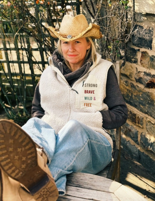 Woman wearing unisex Sherpa Gilet in stone