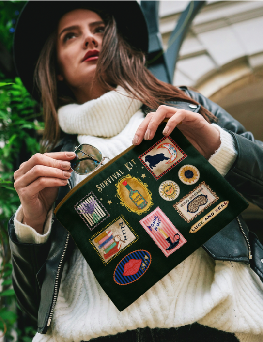 Woman holding The Survival Kit Pouch in dark green