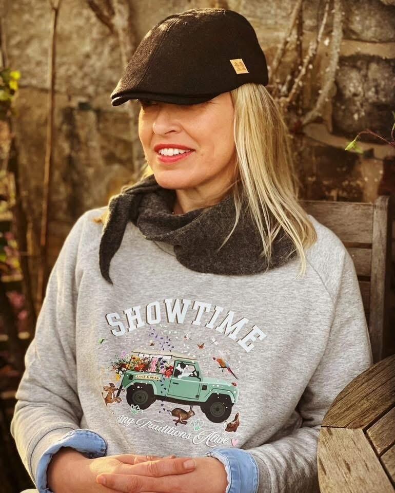 Woman wearing light grey Showtime sweatshirt