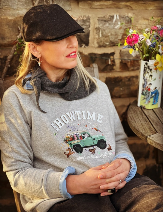 Woman wearing grey Showtime Sweatshirt , neck scarf and Zac cap