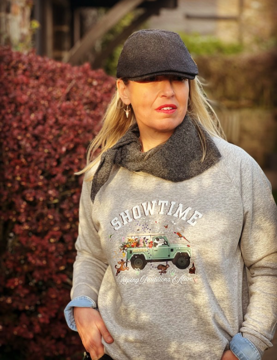 Woman wearing grey Showtime Sweatshirt , neck scarf and Zac cap