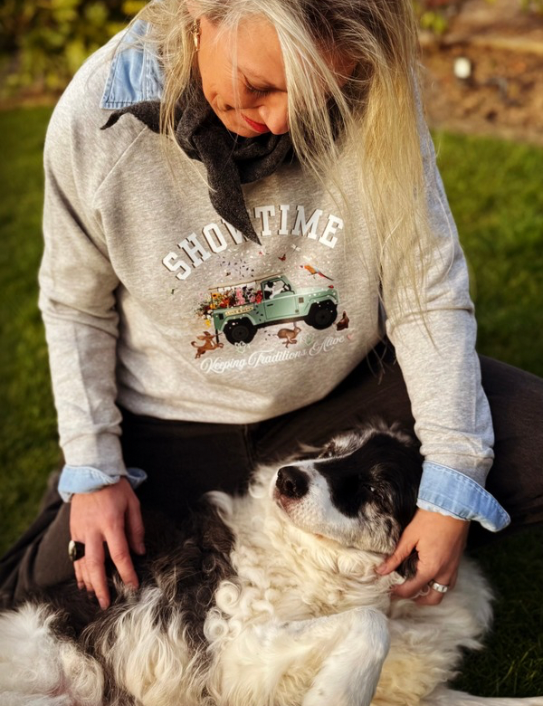 Woman wearing grey Showtime Sweatshirt , neck scarf and Zac cap