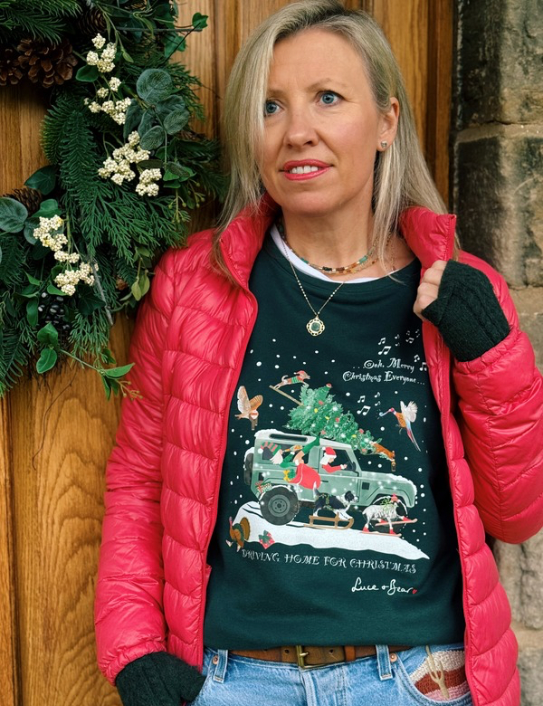 Woman wearing Driving Home for Christmas dark green sweatshirt