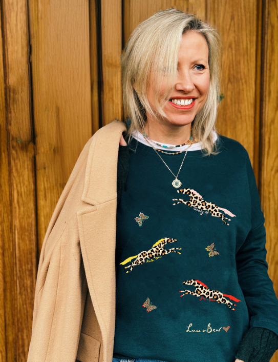 Woman wearing Fire Horse Sweatshirt in dark green