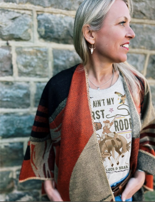 Woman wearing cashmere blend Warrior Wrap in orange