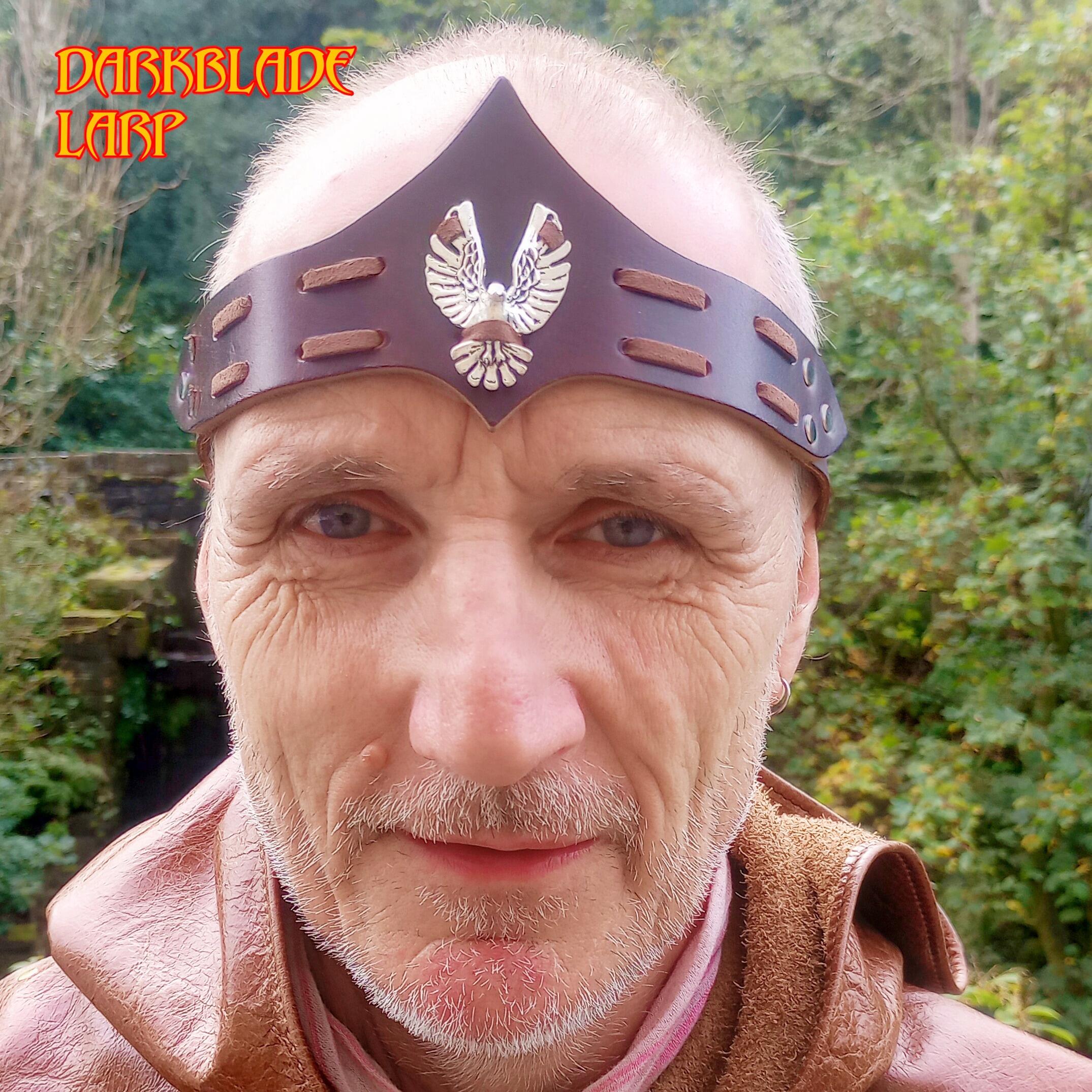 A leather headband with a metal hawk laced to it