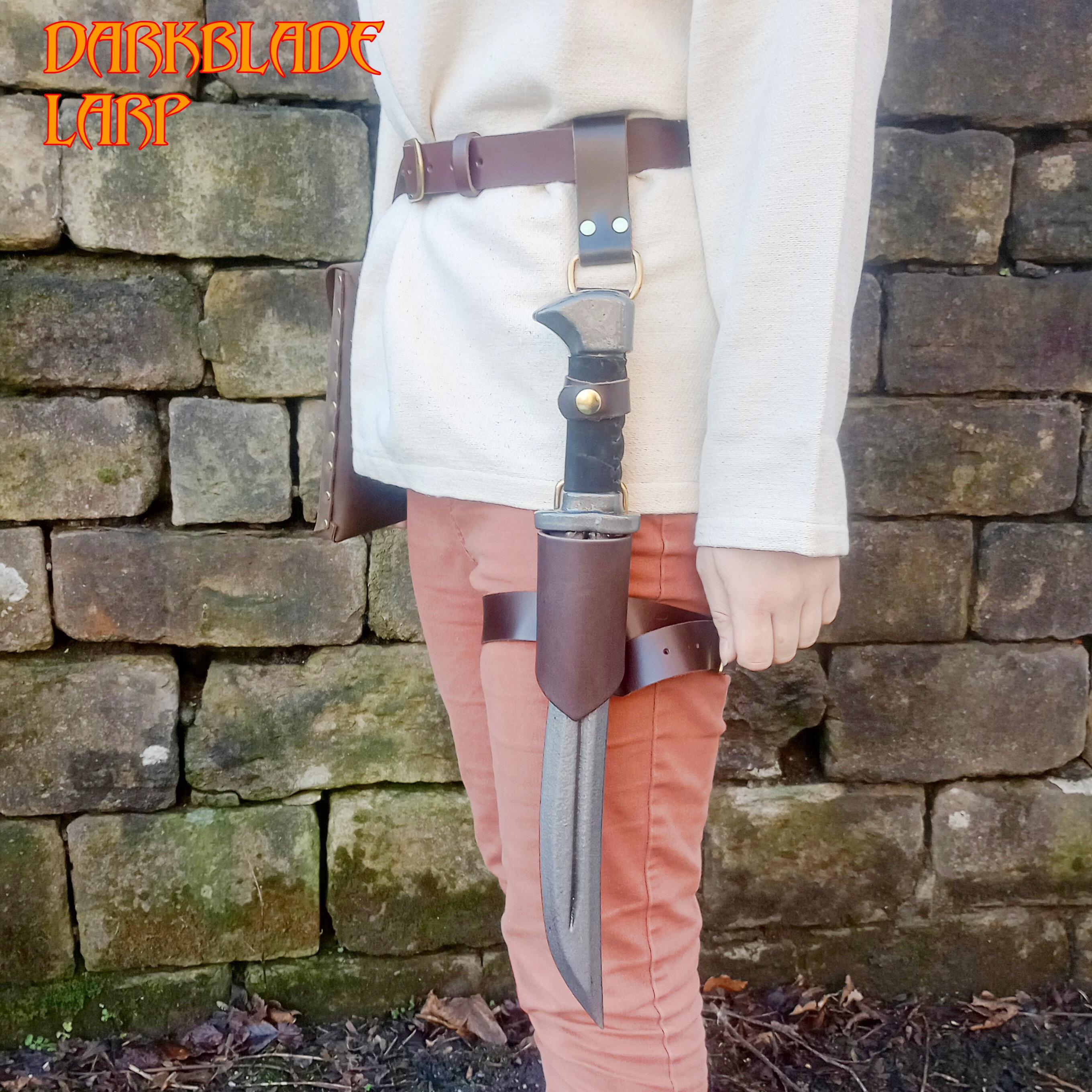 A dagger in a scabbard with a belt designed to hold it to the thigh