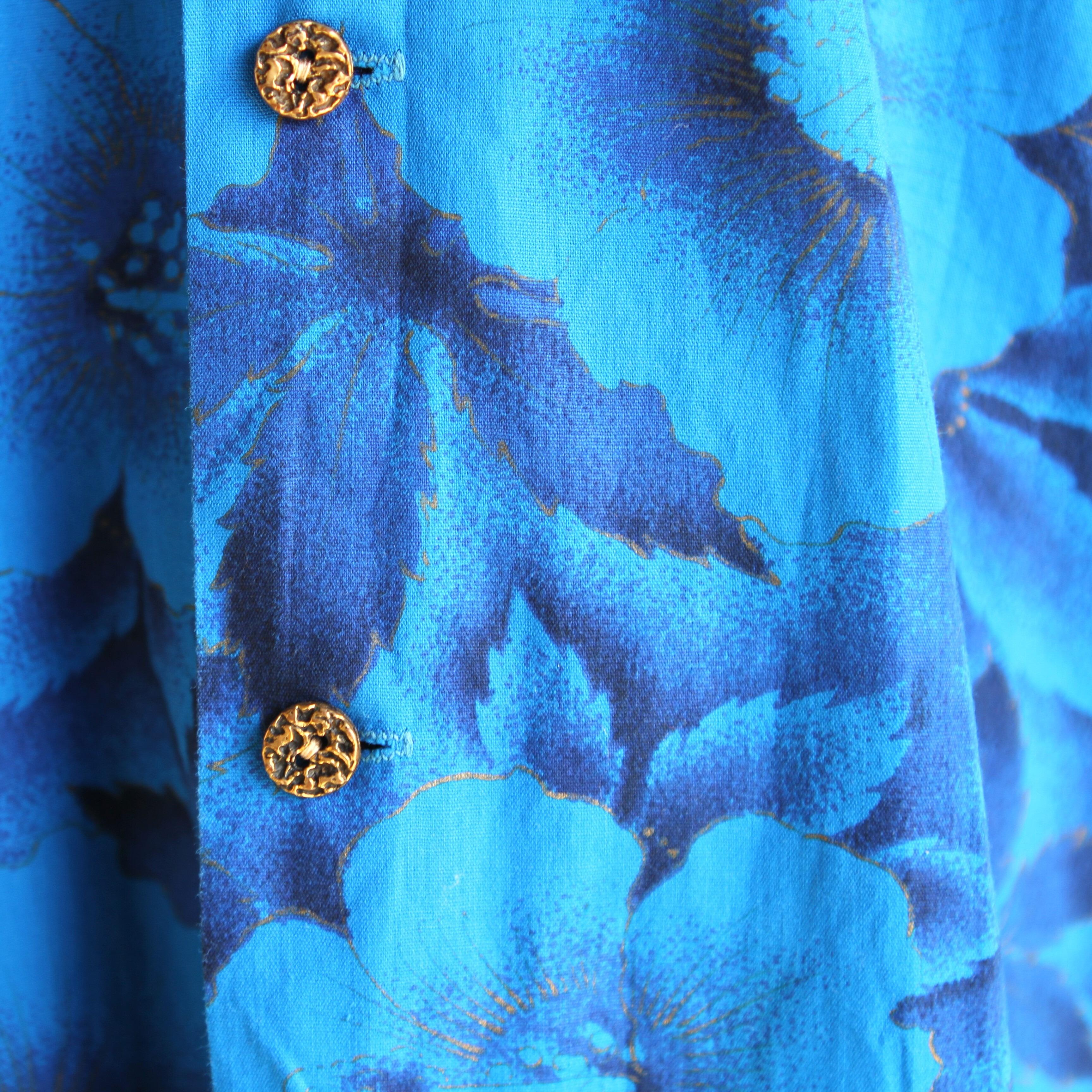 amazing original vintage 60s Waikiki Wear Hawaiian shirt in blue with a floral design in blues black and gold- very cool- detail