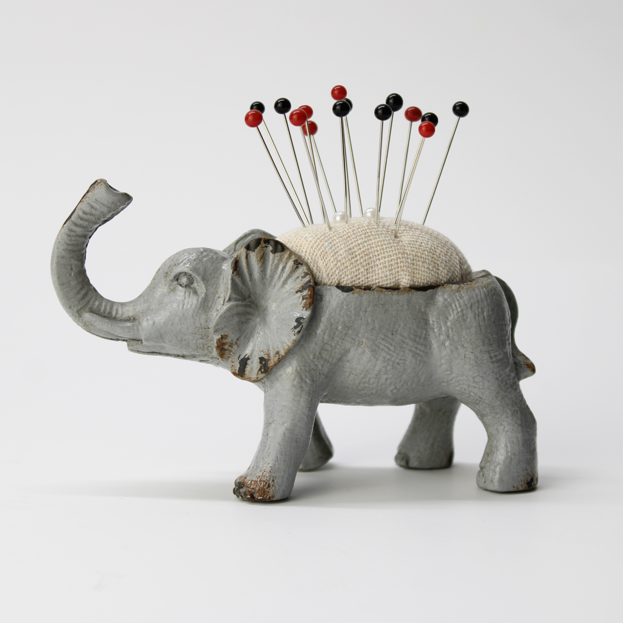 Cast iron elephant pincushion with a rustic paint finish