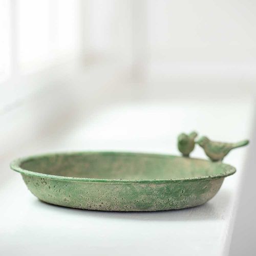 Rustic green shallow trinket dish with two bird figurines perched on the rim