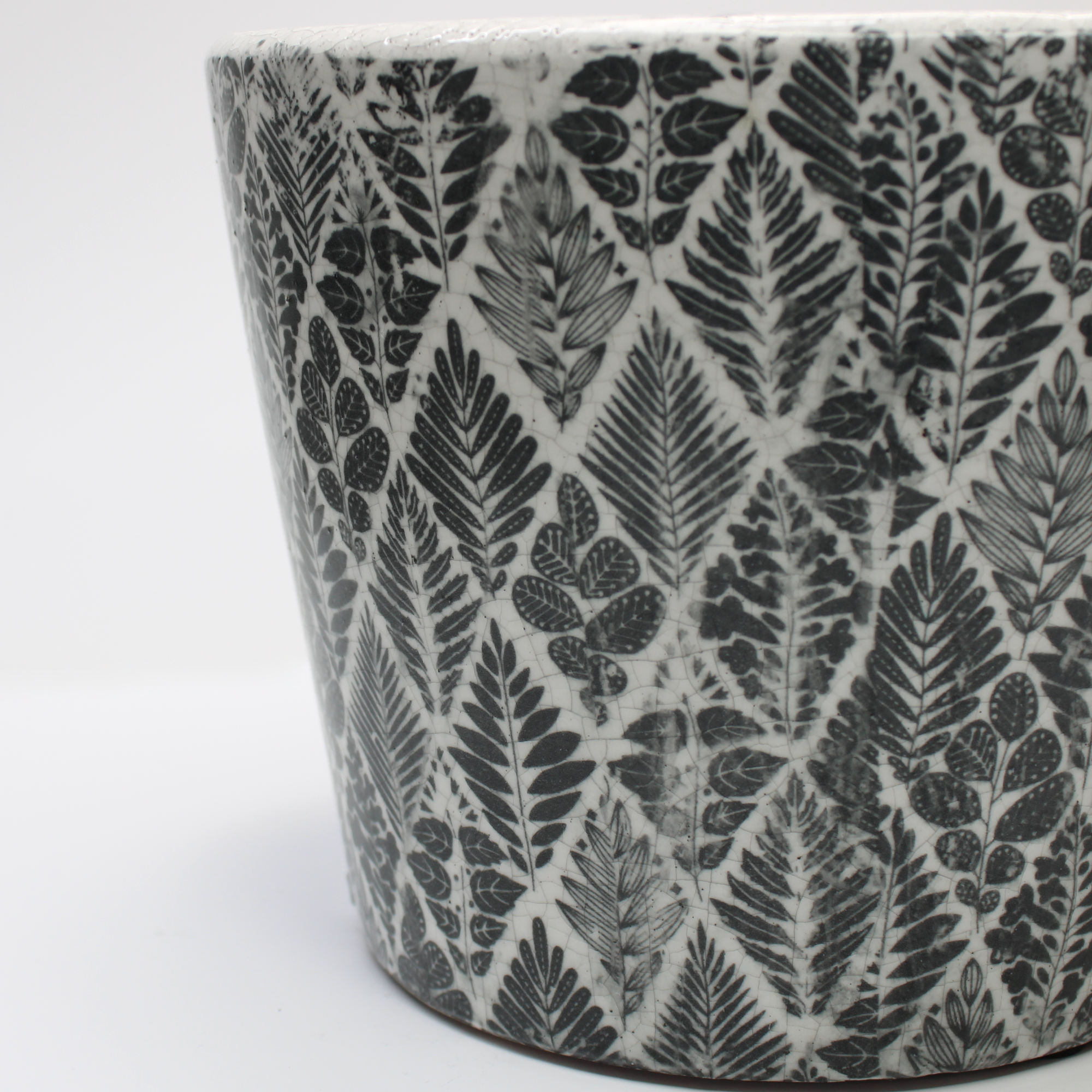 closeup of plant pot focusing on the black and white glazed vintage design