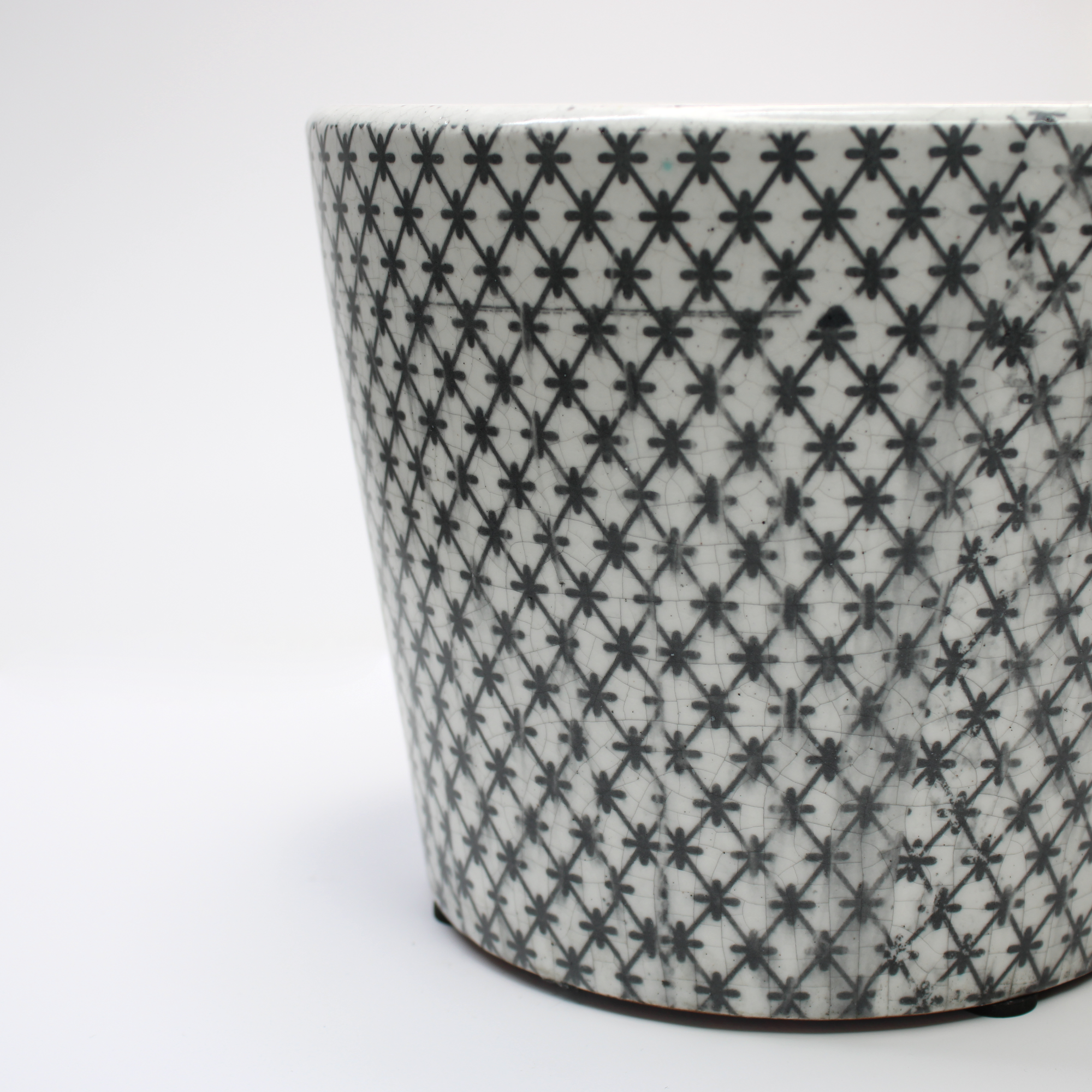 closeup of a vintage-style black and white glazed plant pot