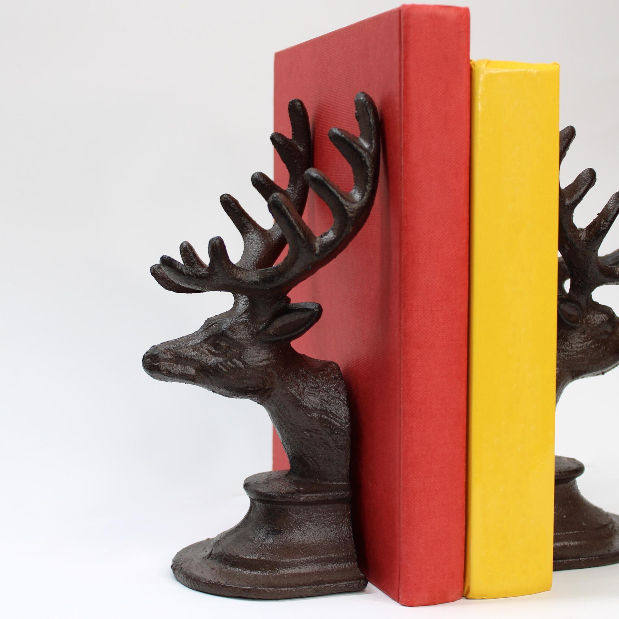 Pair of antique-style iron stag bookends with books.