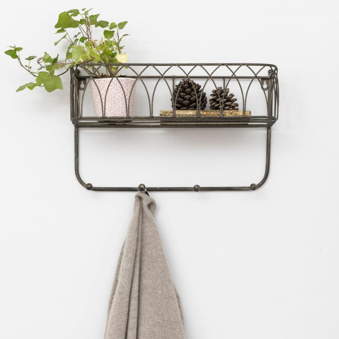 metal coat rack with gothic-arch detailing on the top shelf