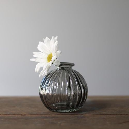 small grey ribbed glass bud vase with flower stem