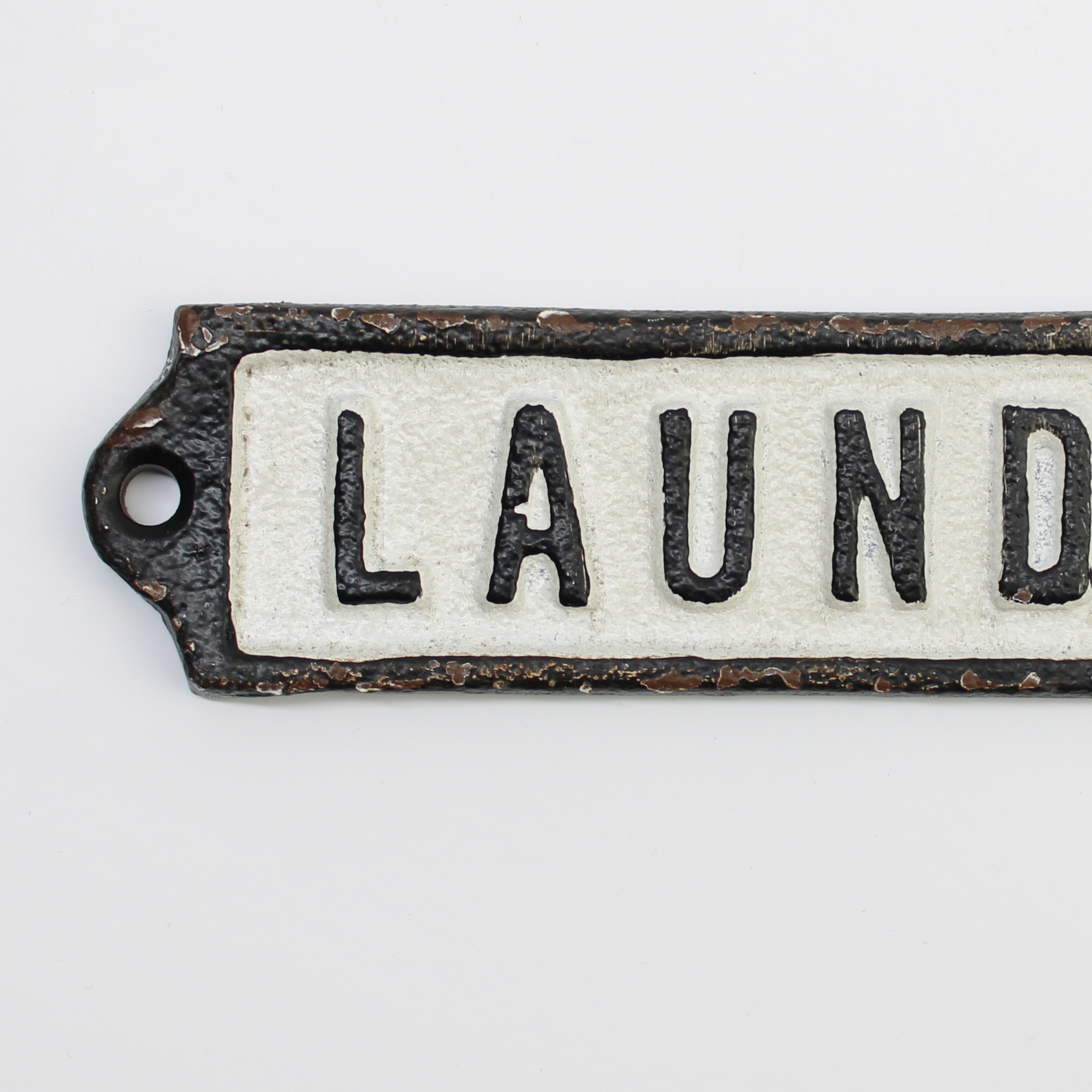 closeup of vintage-style cast metal Laundry room sign with weathered paint
