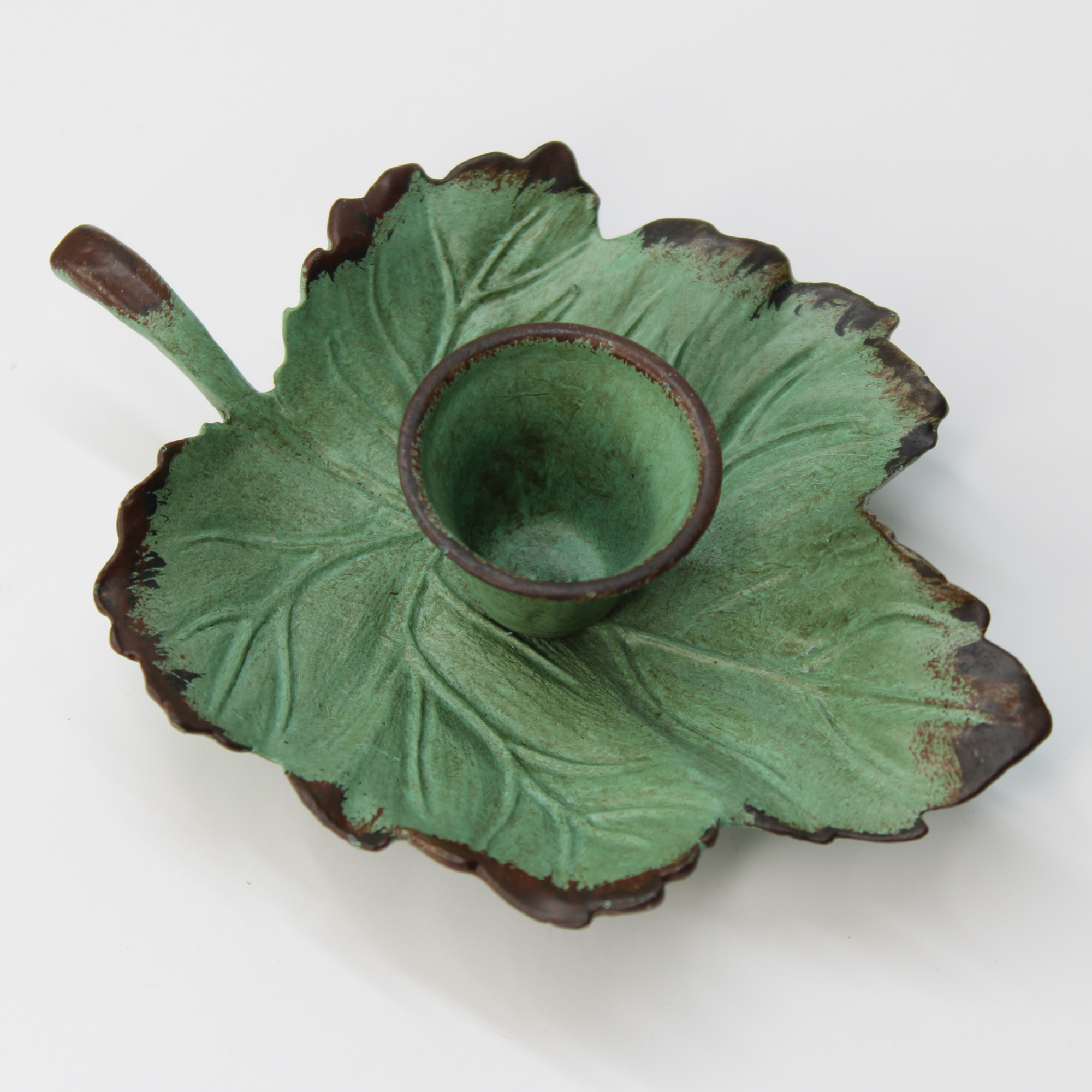 decorative green candle holder with antique ivy leaf pattern