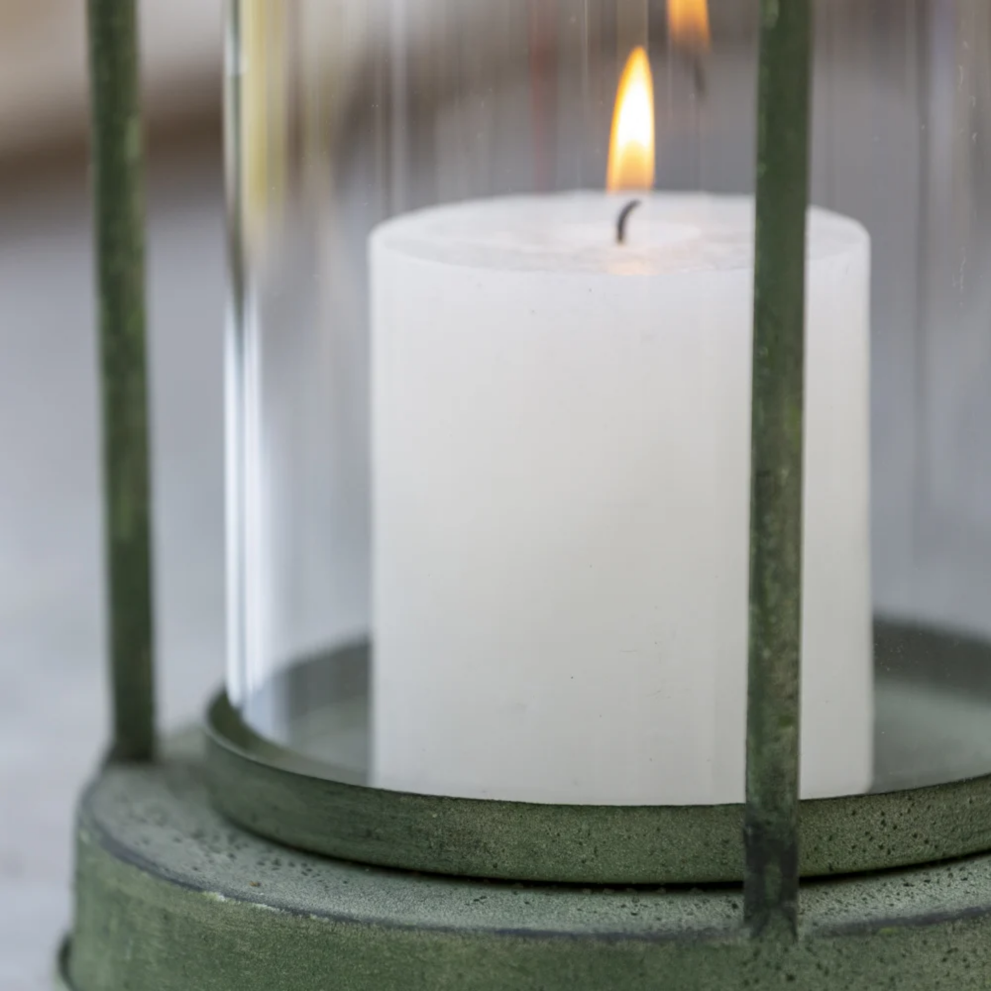 Close up vintage green metal hurricane lantern with glass