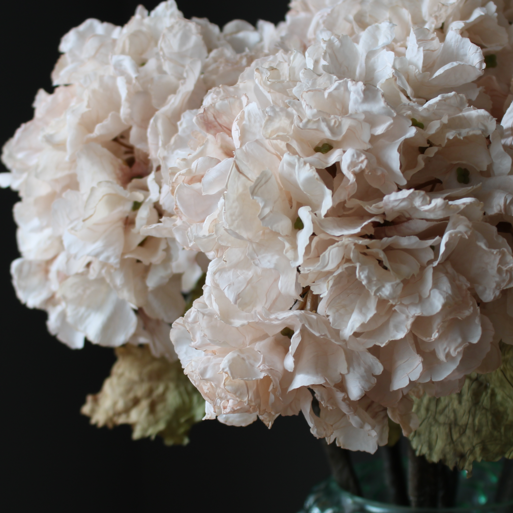 close up of an artificial real touch cream hydrangea flower