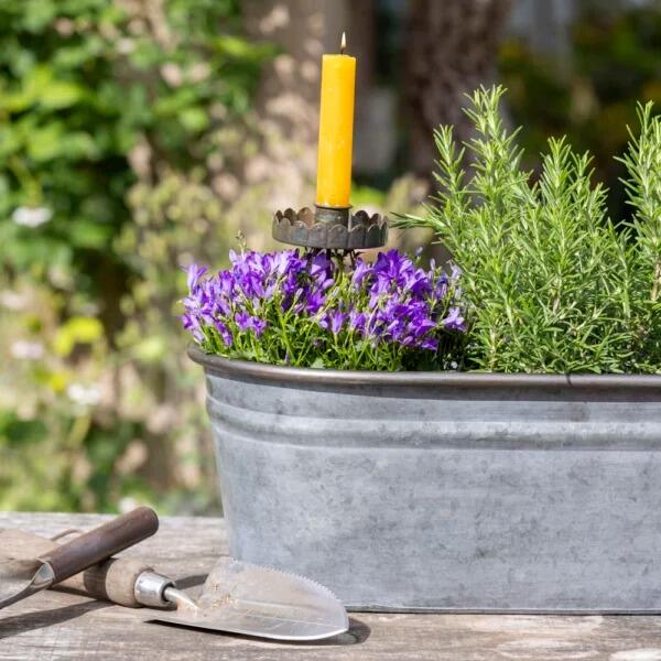 Rustic metal garden stake candle holder in planter