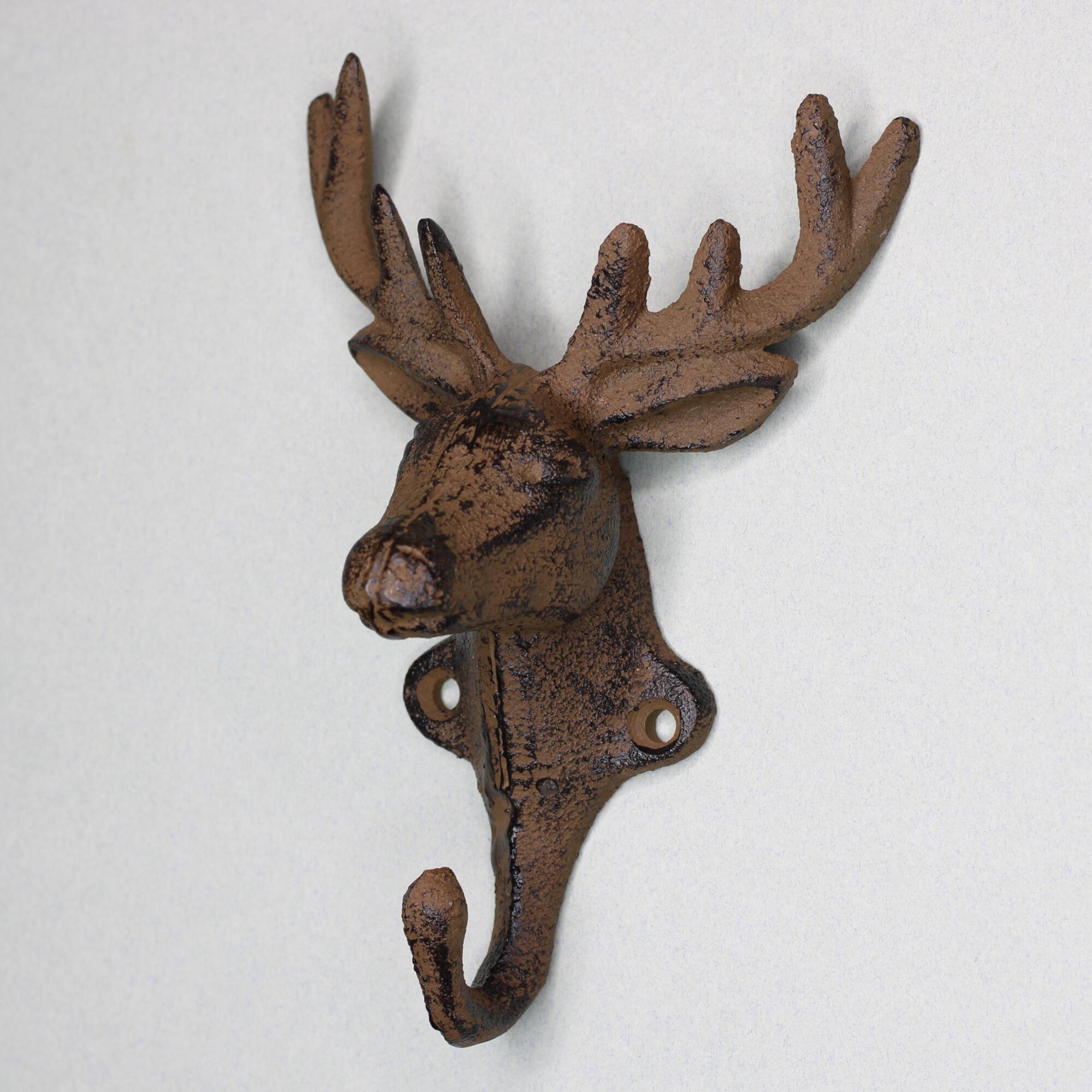 Close-up of a decorative cast iron stag head wall hook side view.