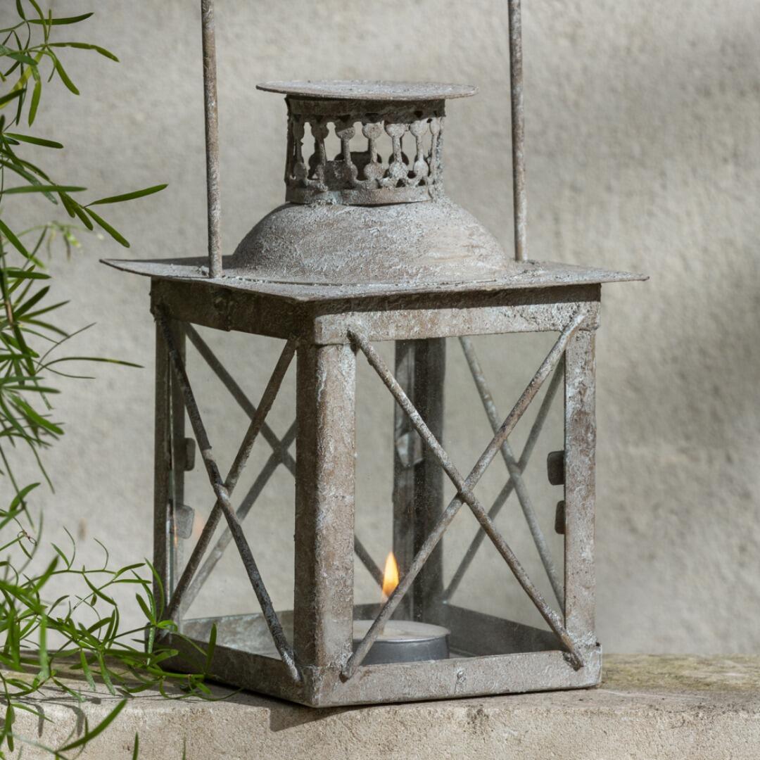 Closeup of a rustic candle lantern in the garden