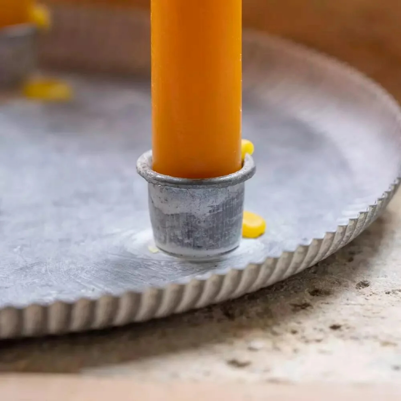 Closeup of metal candle tray holder