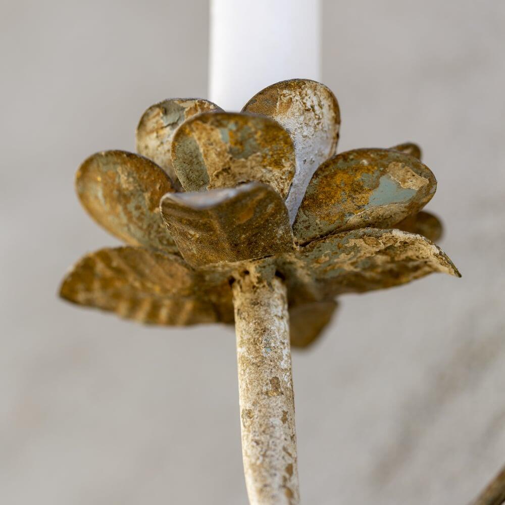 rustic wall sconce closeup of distressed layered paint finish of the candle arm