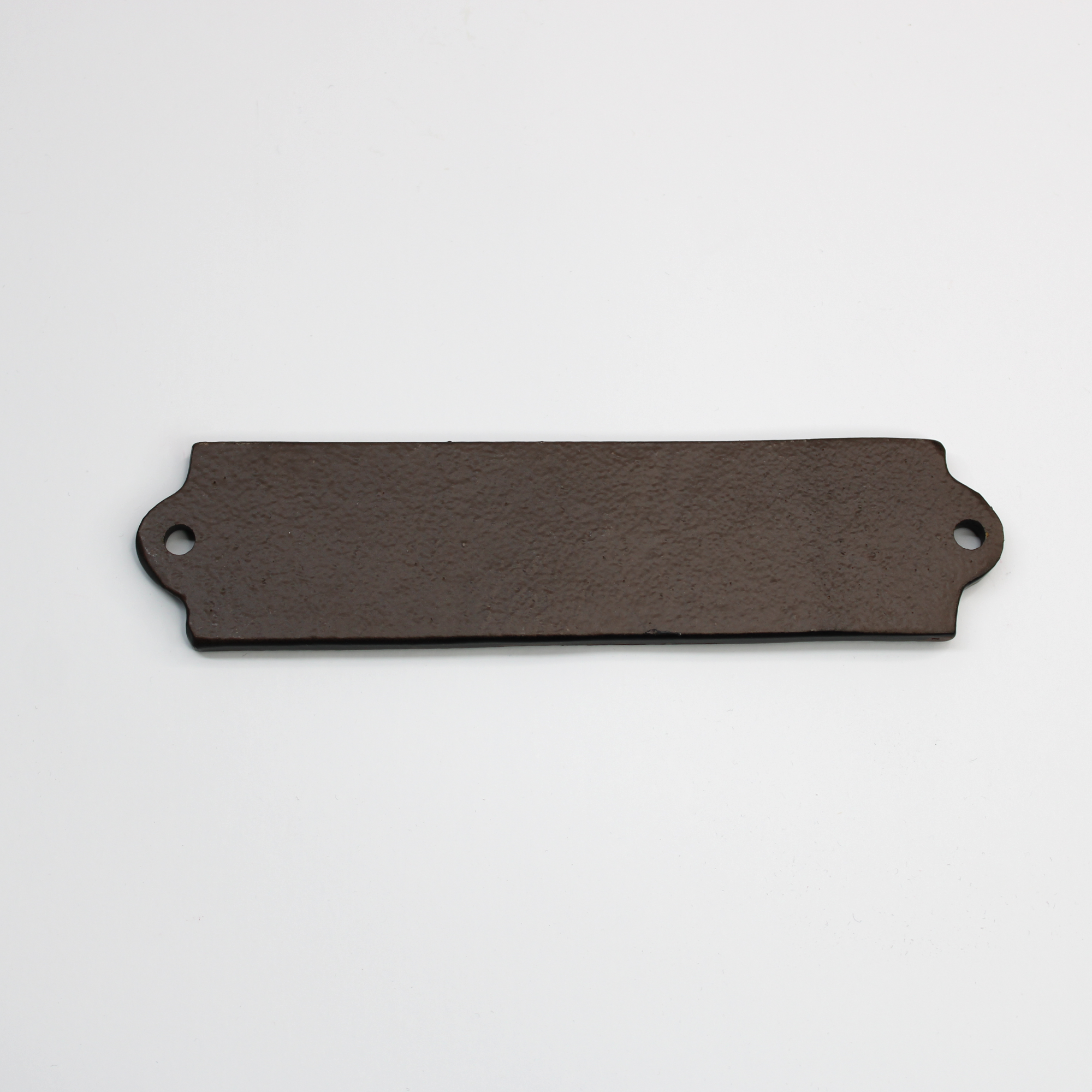 Reverse side of rectangular cast iron toilet sign.