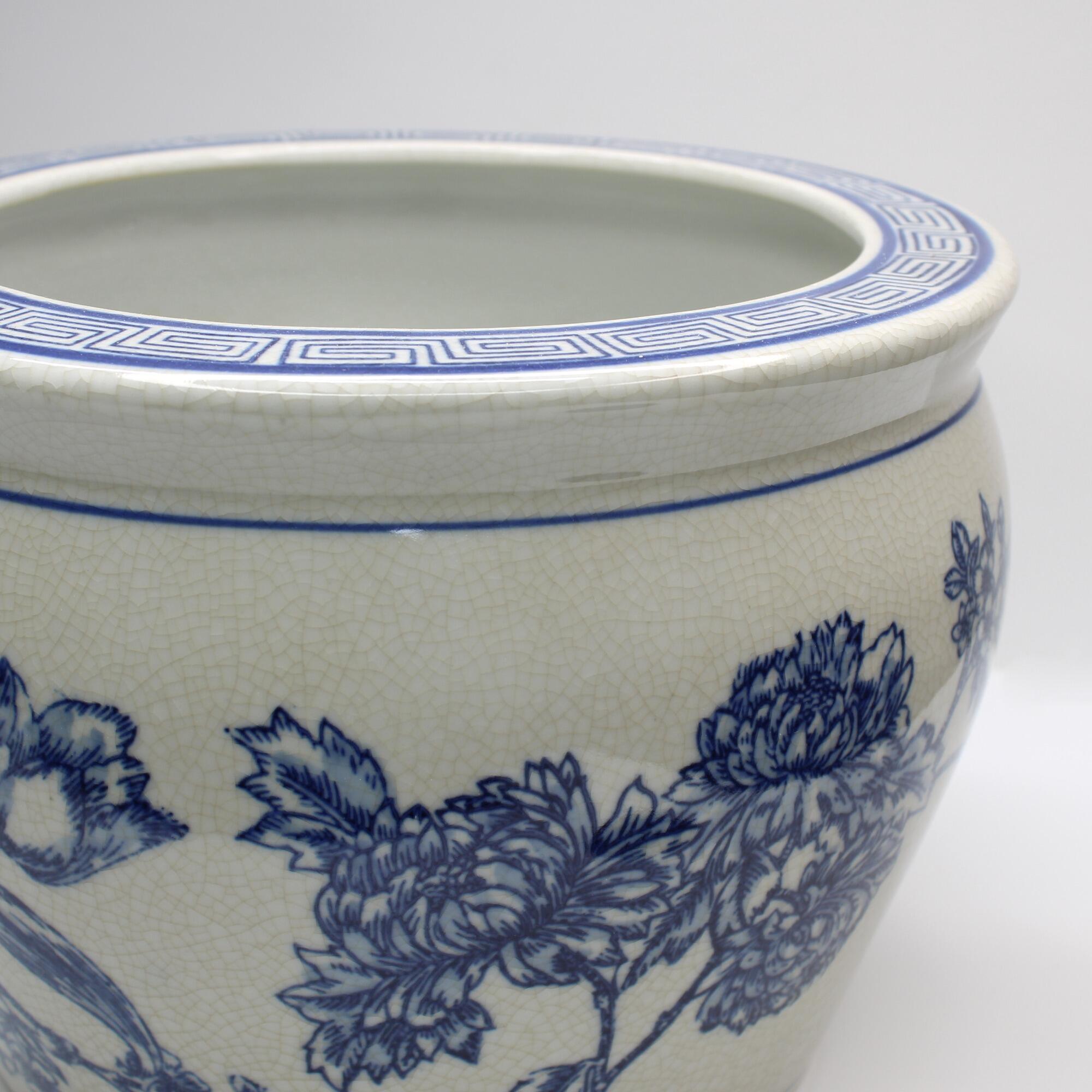 Vintage style pot with blue botanical design.