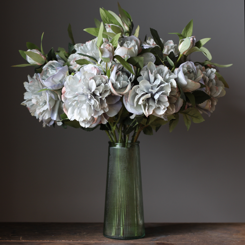 artificial peony flower stems with realistic blooms in a vintage green tall vase