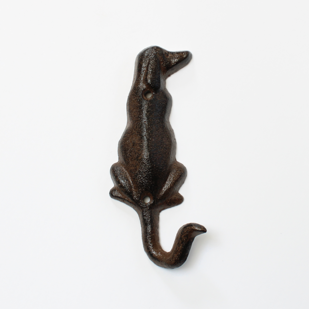Detailed view of the cast iron dog tail hook, showcasing its rustic texture and sturdy design.