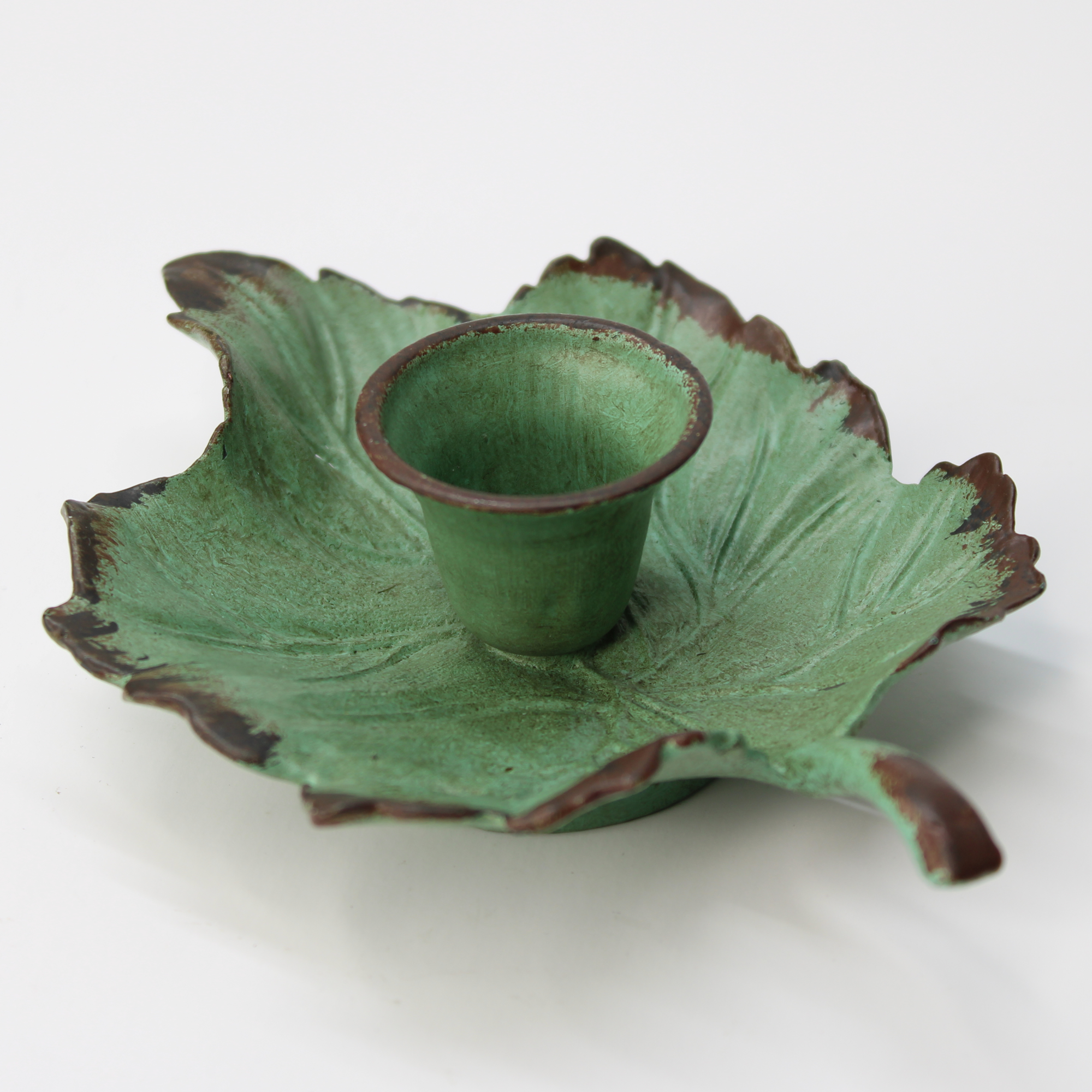 leaf-shaped cast iron candle holder in rustic green