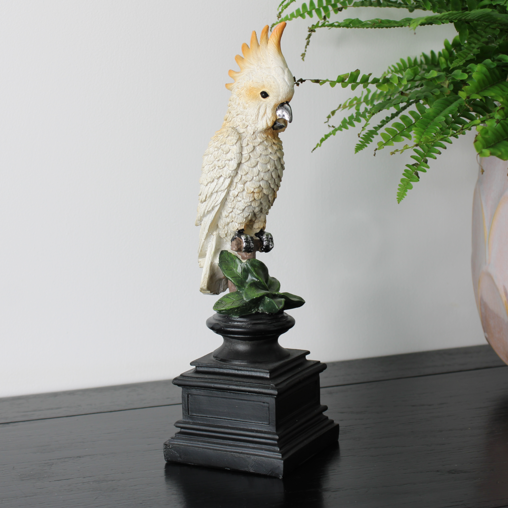 White Sulphur-Crested Cockatoo statue on a black pedestal base.