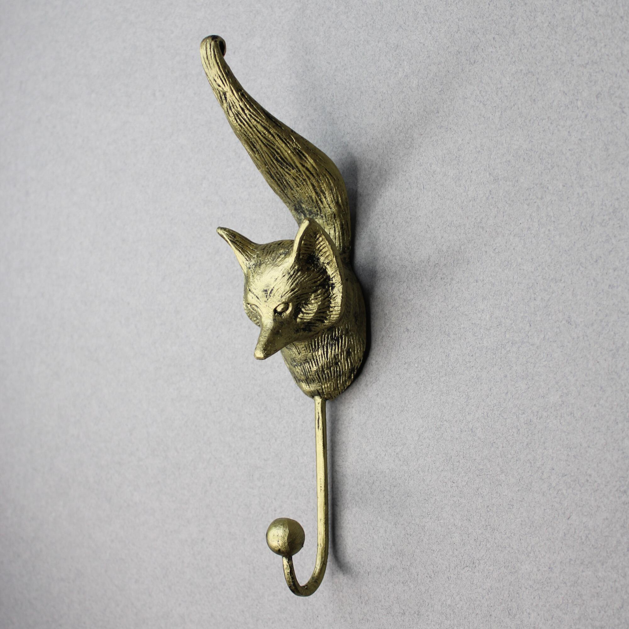Gold fox head wall hook with detailed textured fur and an upward-curving tail.