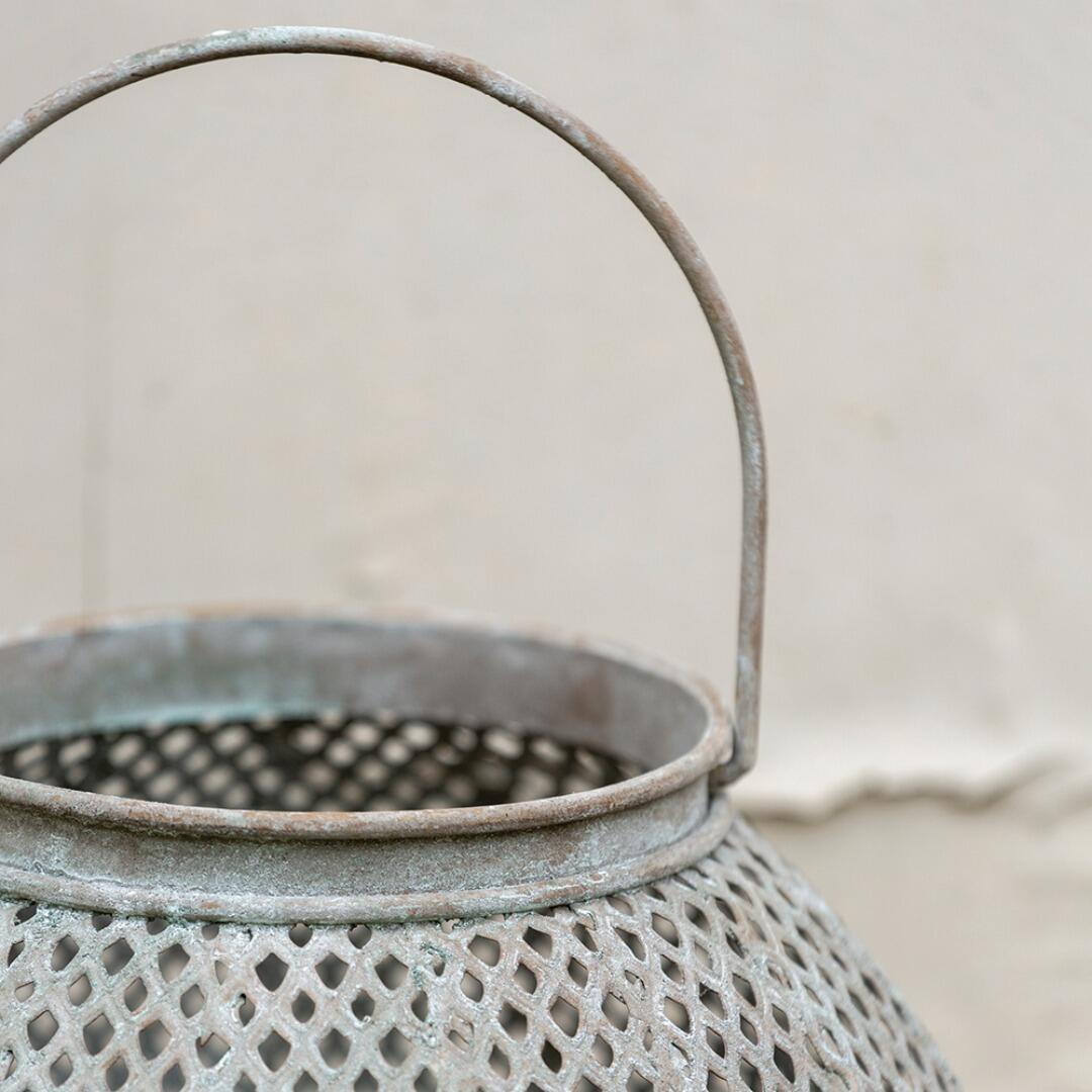 Closeup of a weathered lantern focusing on the handle.