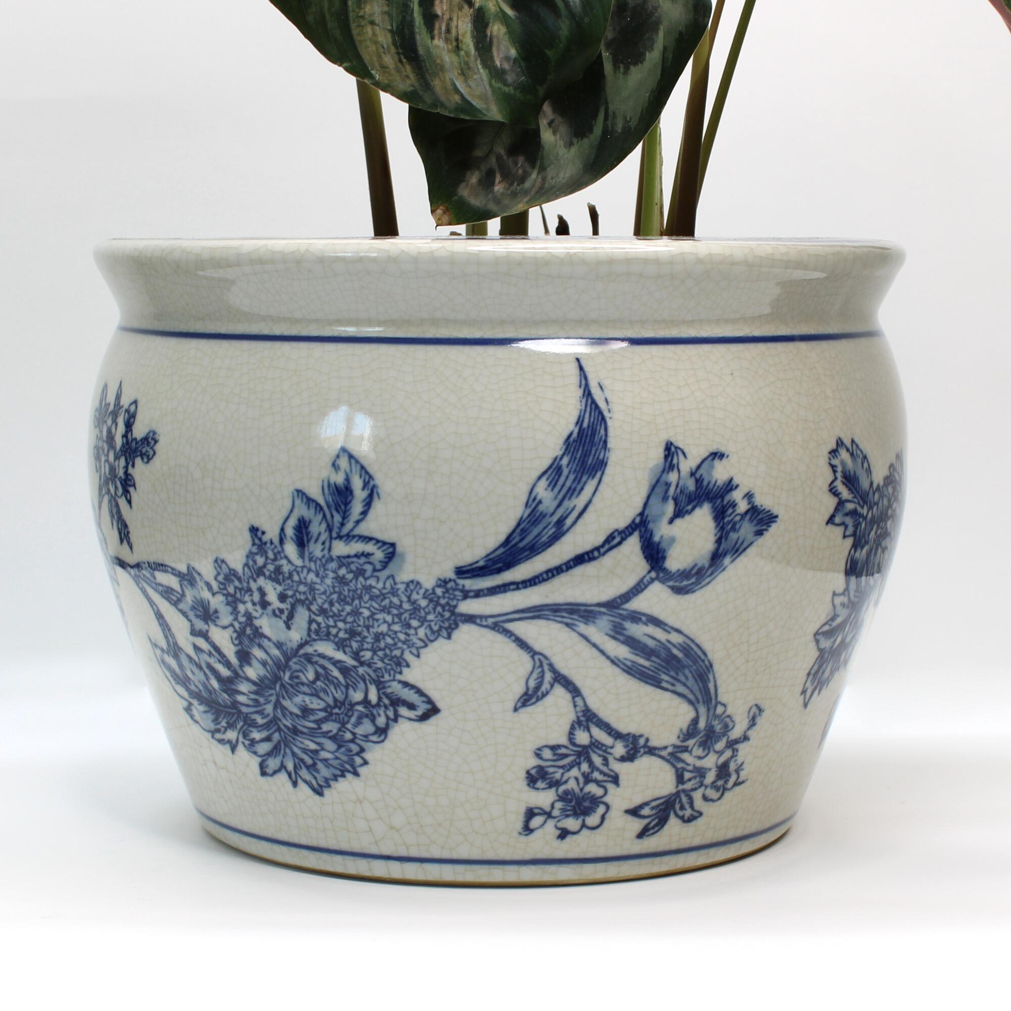 blue and white ceramic planter featuring an antique-inspired floral motif.