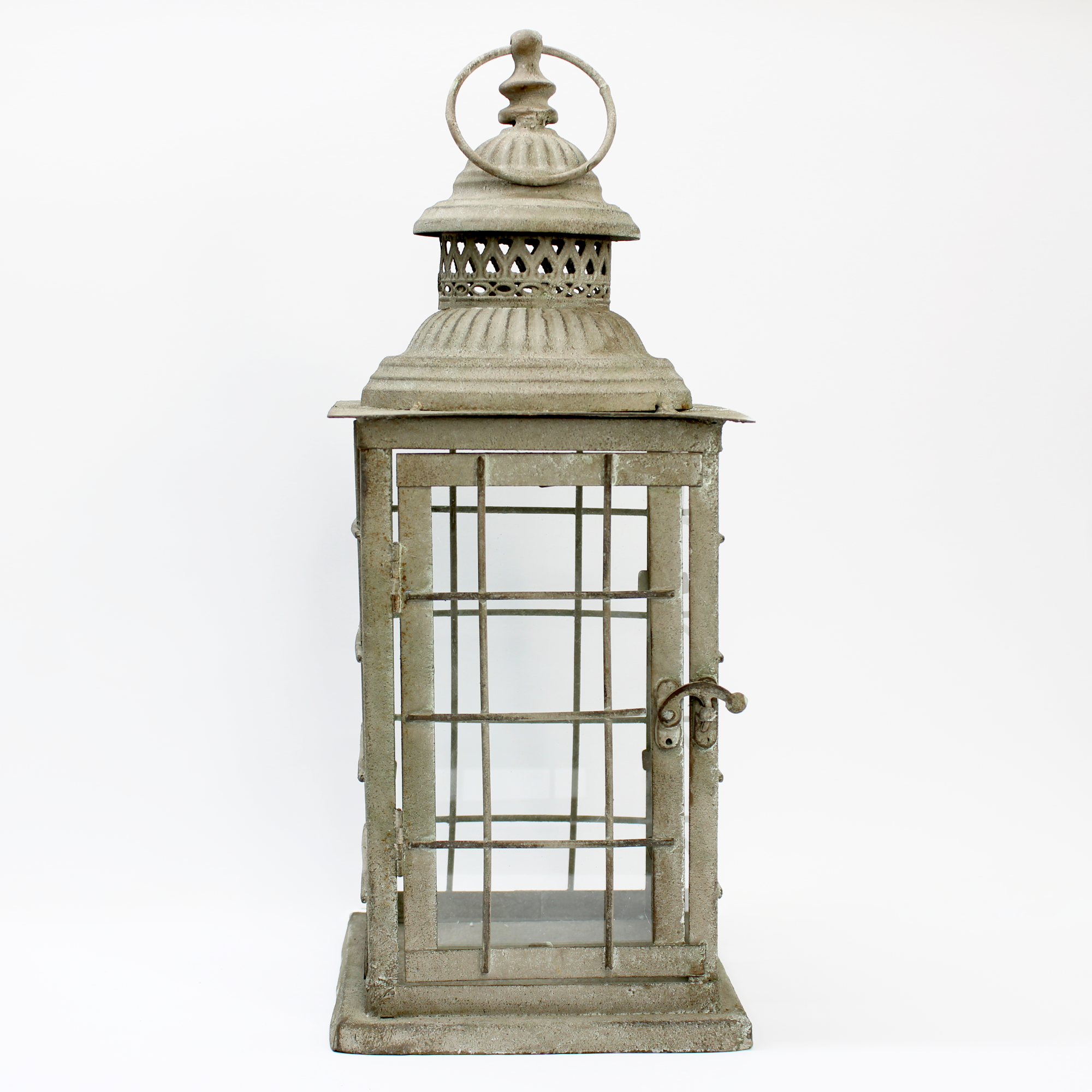 Rustic pillar candle lantern featuring weathered metal and clear glass.