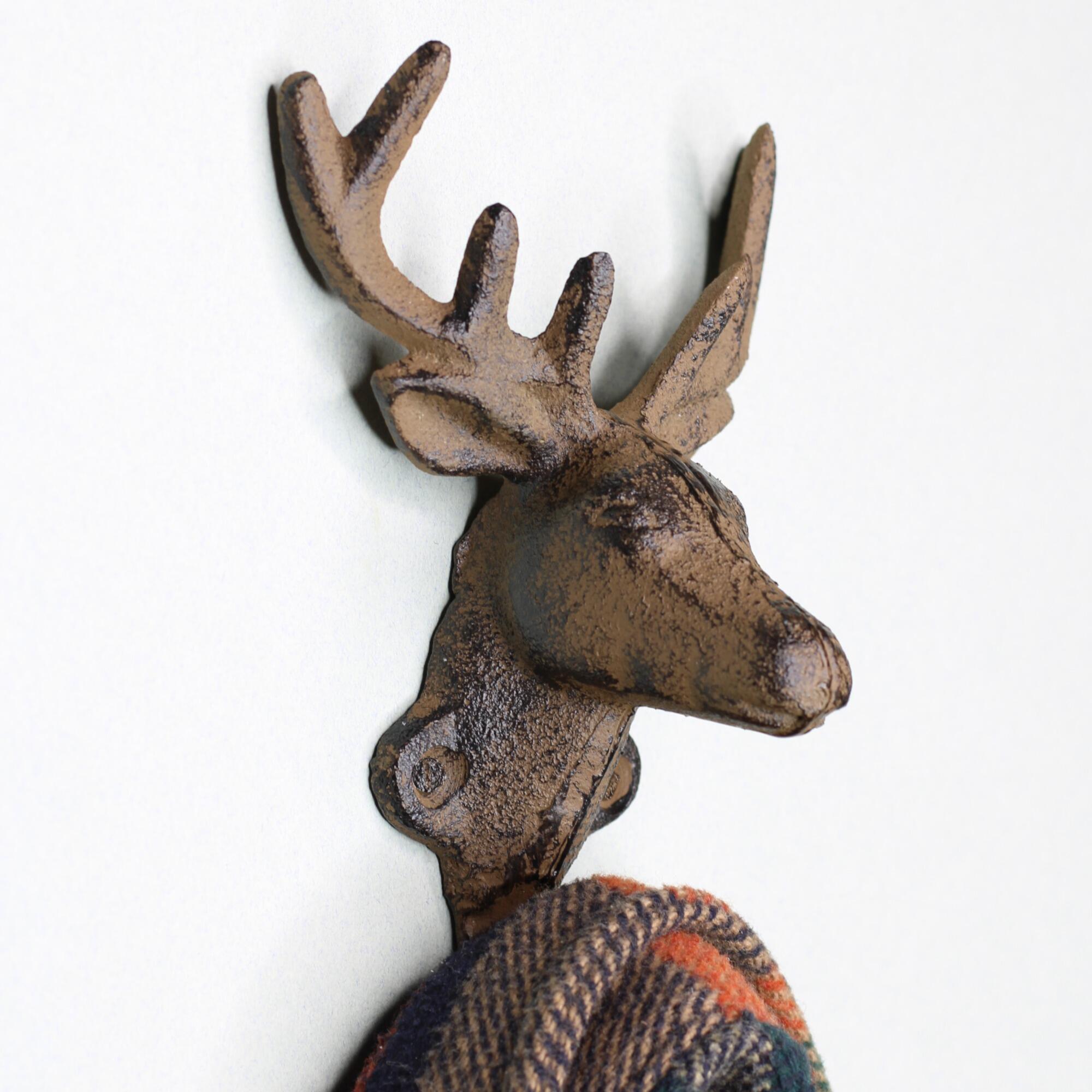 Side profile of a heavy-duty stag head coat hook showing the depth and sturdy cast iron construction for hanging heavy coats.