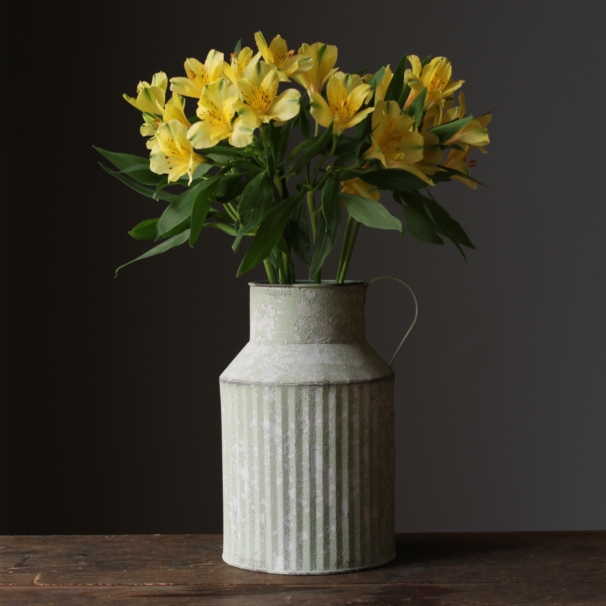 vintage milk churn used as a vase with fresh flowers