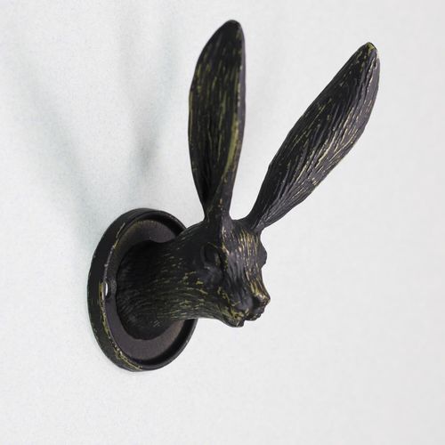Detailed side view of a black rustic hare head wall hook featuring long upright ears.