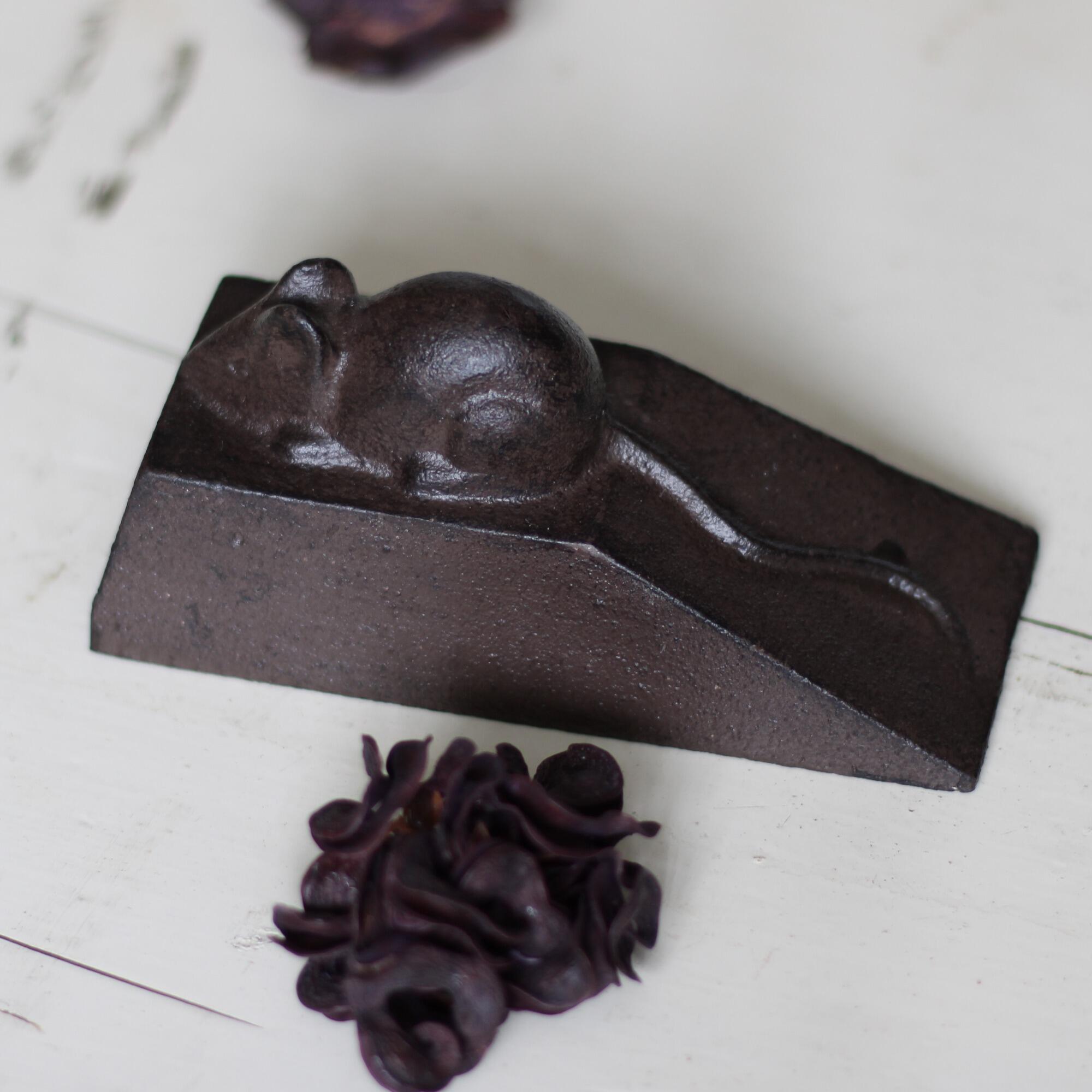 Rustic style doorstop with a sleeping mouse.