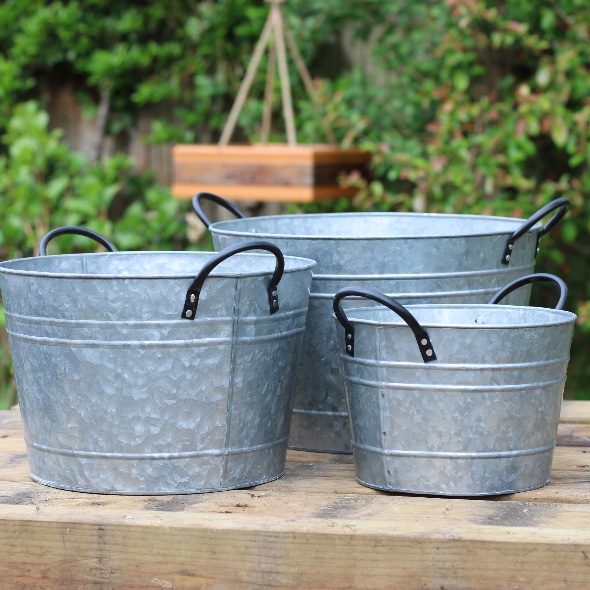 Set of 3 metal garden planter tubs.